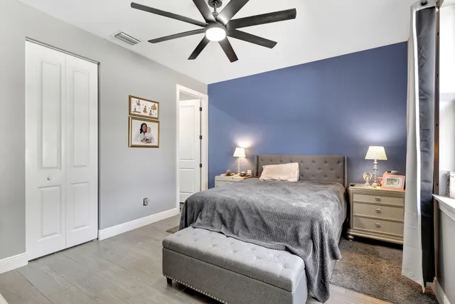 a bedroom with a bed and a chandelier