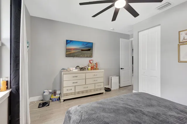 a room with a bed and a flat tv screen