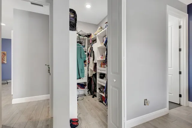 a view of a hallway with closet and a white door
