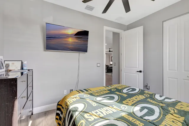 a bedroom with a bed and a flat screen tv