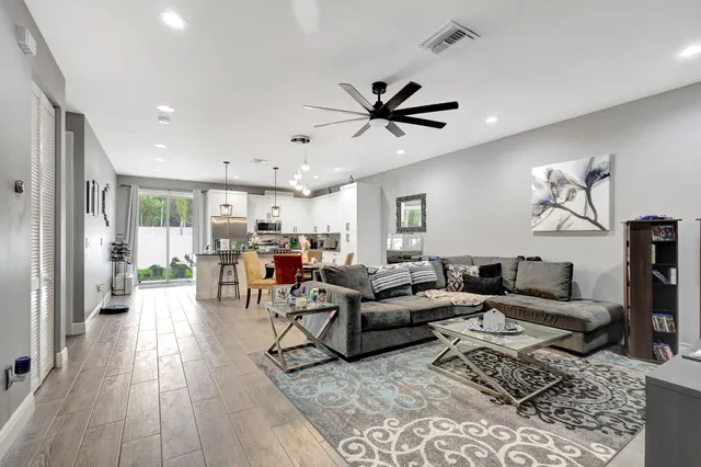 a living room with furniture and a wooden floor