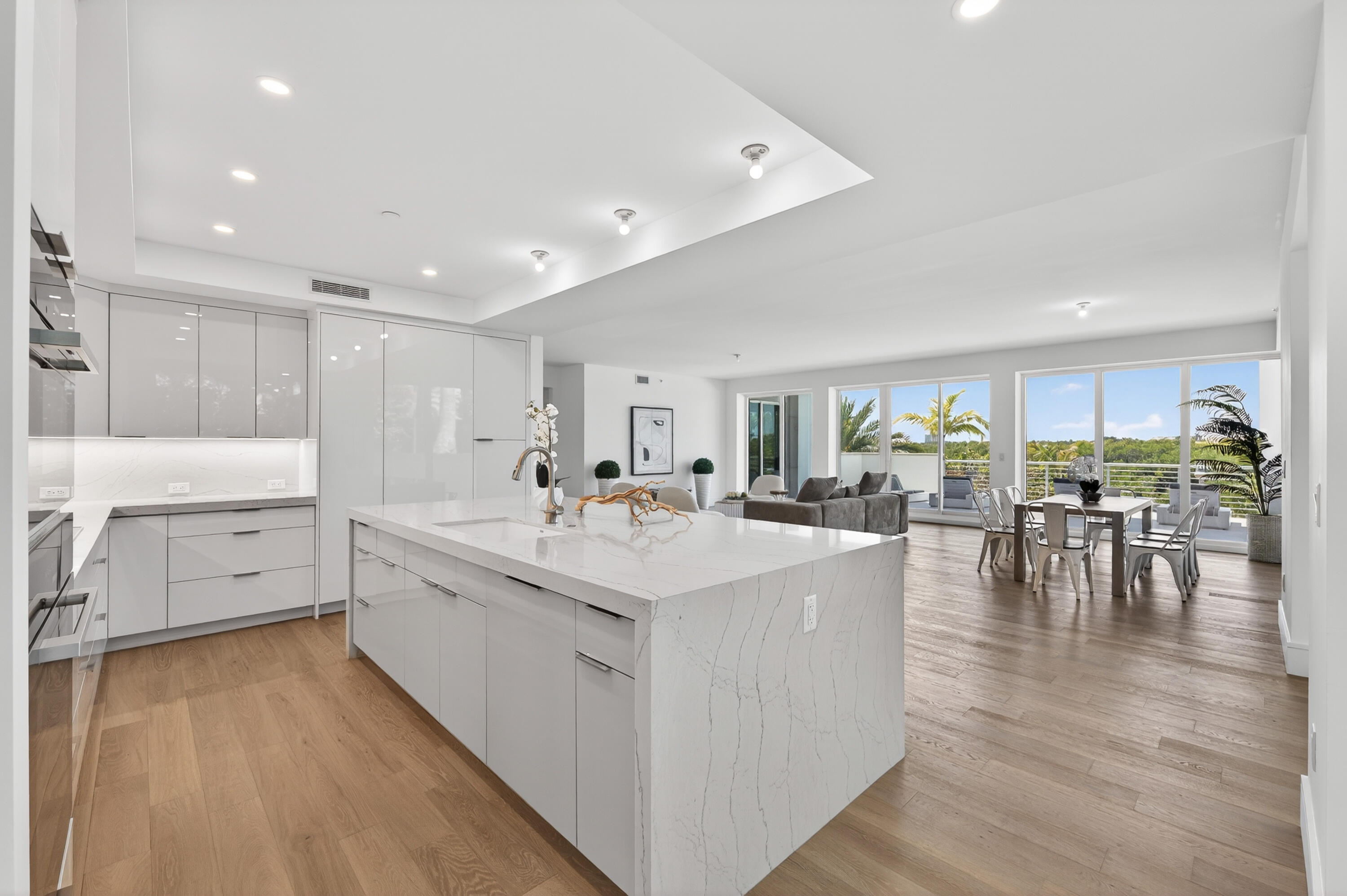 1 South Coastal Way, Unit 201 Jupiter, FL 33477 - Photo 12 of 40 a large white kitchen with lots of counter space a sink and appliances