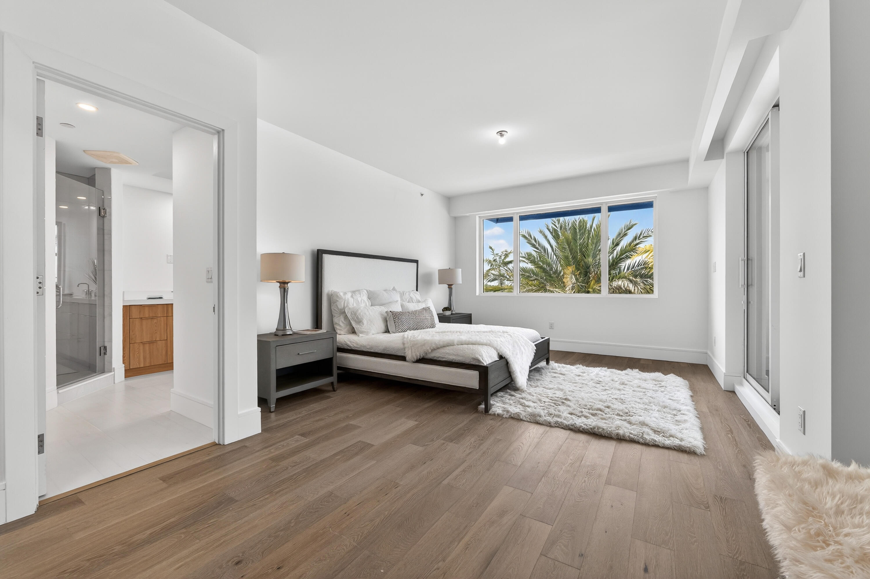 1 South Coastal Way, Unit 201 Jupiter, FL 33477 - Photo 13 of 40 a bedroom with furniture and a wooden floor