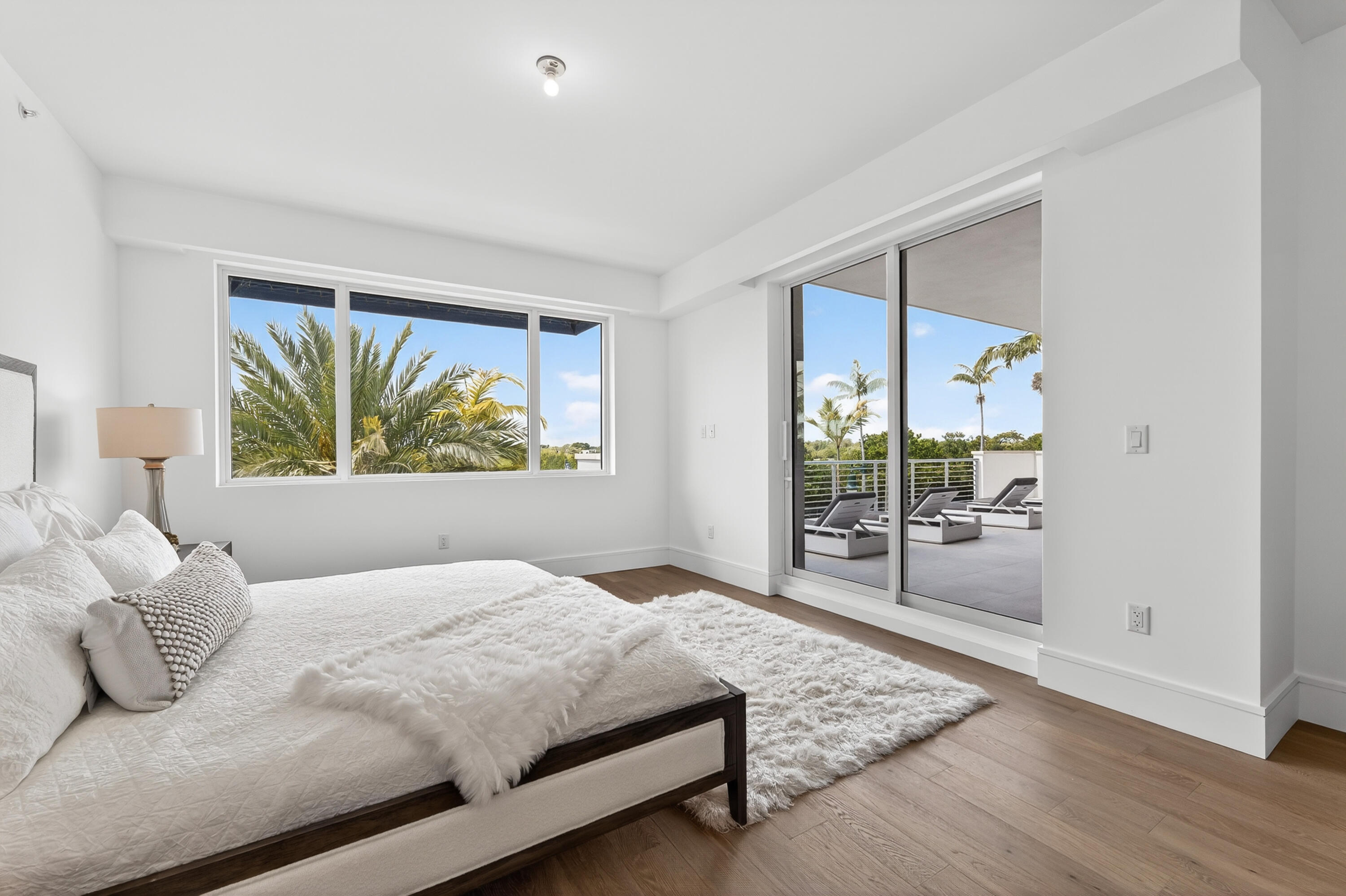 1 South Coastal Way, Unit 201 Jupiter, FL 33477 - Photo 15 of 40 a bedroom with a large bed and a window