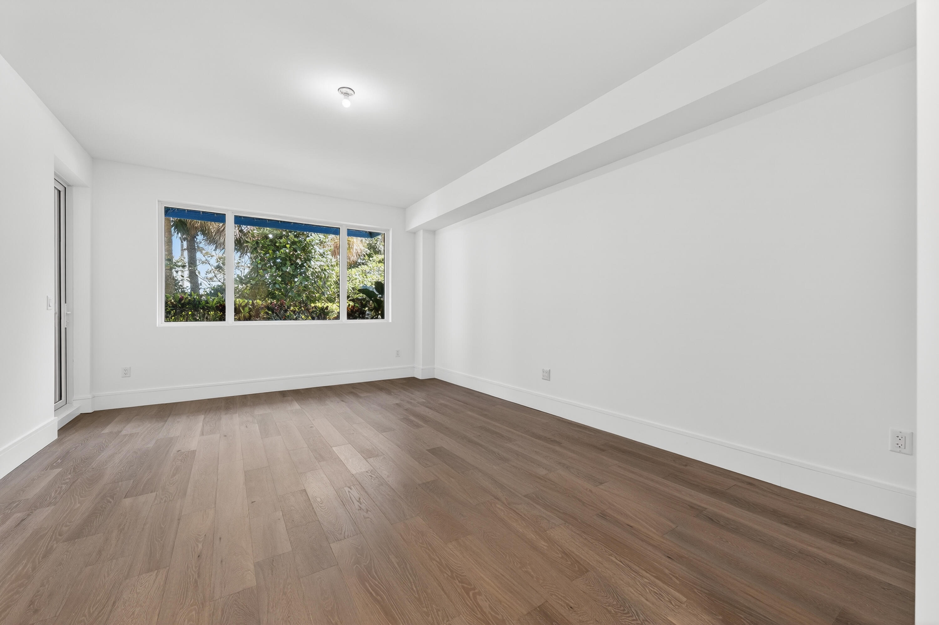 1 South Coastal Way, Unit 201 Jupiter, FL 33477 - Photo 21 of 40 an empty room with wooden floor and windows