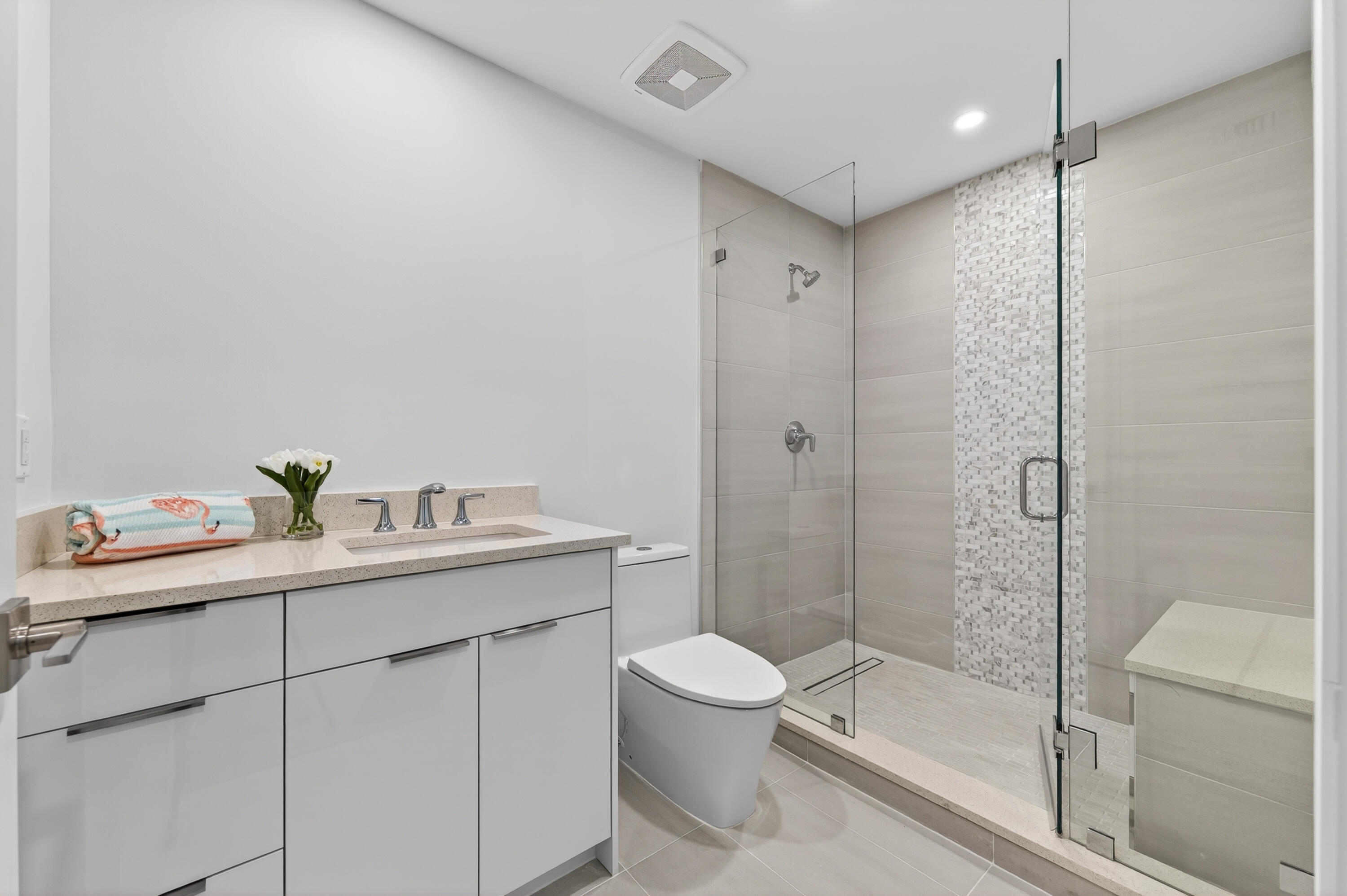 1 South Coastal Way, Unit 201 Jupiter, FL 33477 - Photo 22 of 40 a bathroom with a granite countertop sink a toilet and shower