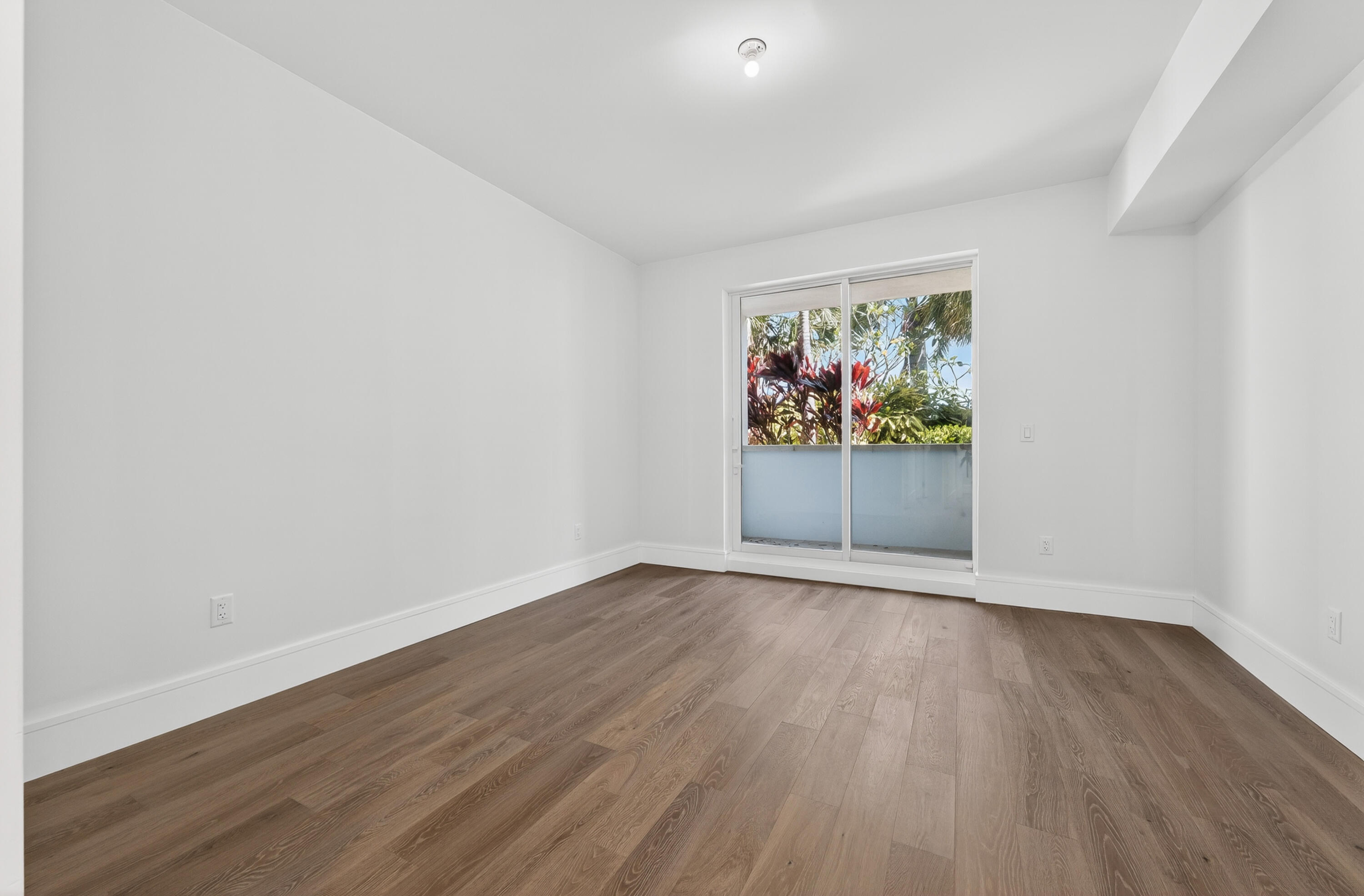 1 South Coastal Way, Unit 201 Jupiter, FL 33477 - Photo 23 of 40 an empty room with wooden floor painting on wall and wooden floor