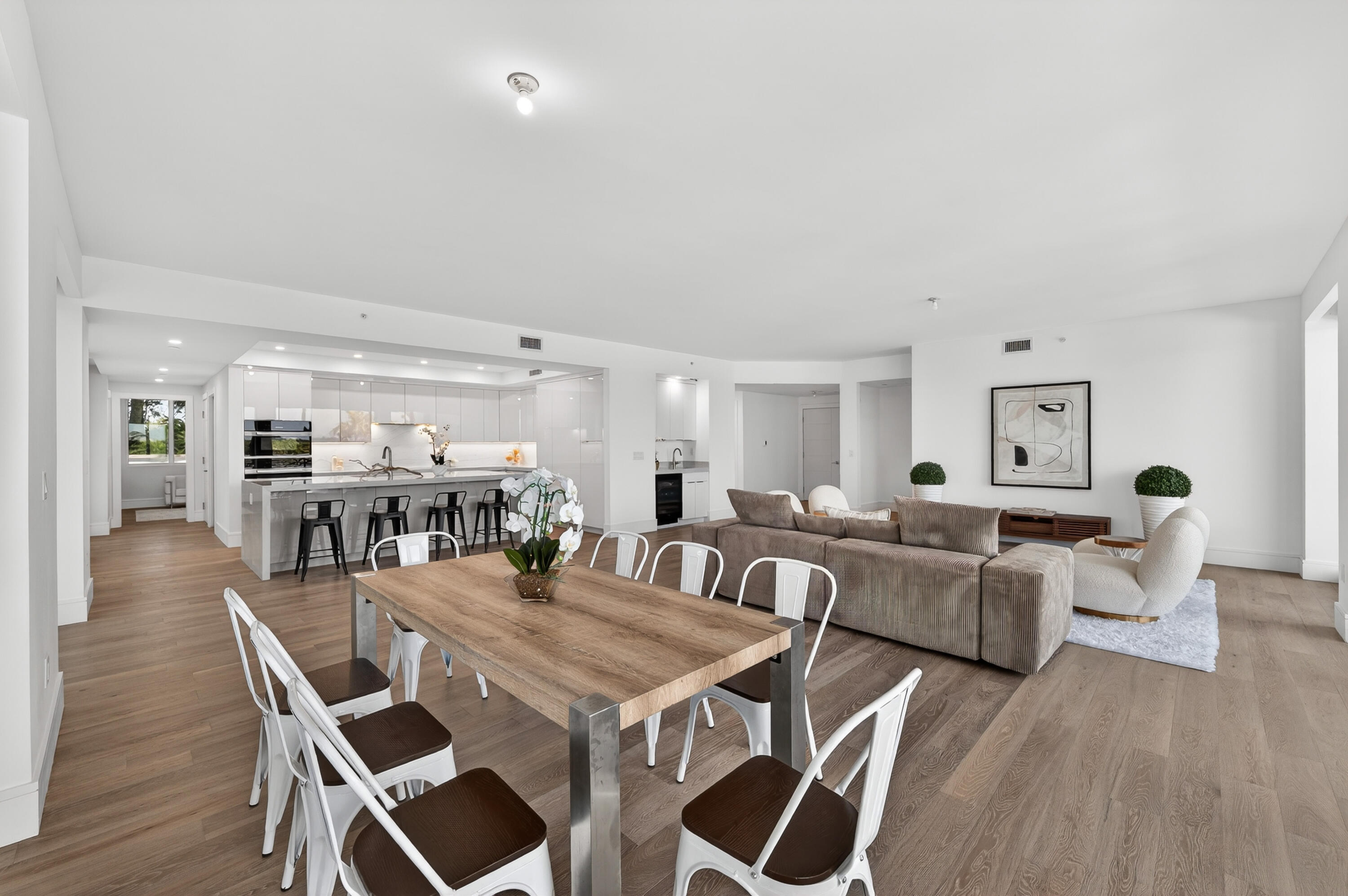 1 South Coastal Way, Unit 201 Jupiter, FL 33477 - Photo 3 of 40 a view of a dining room with furniture and wooden floor