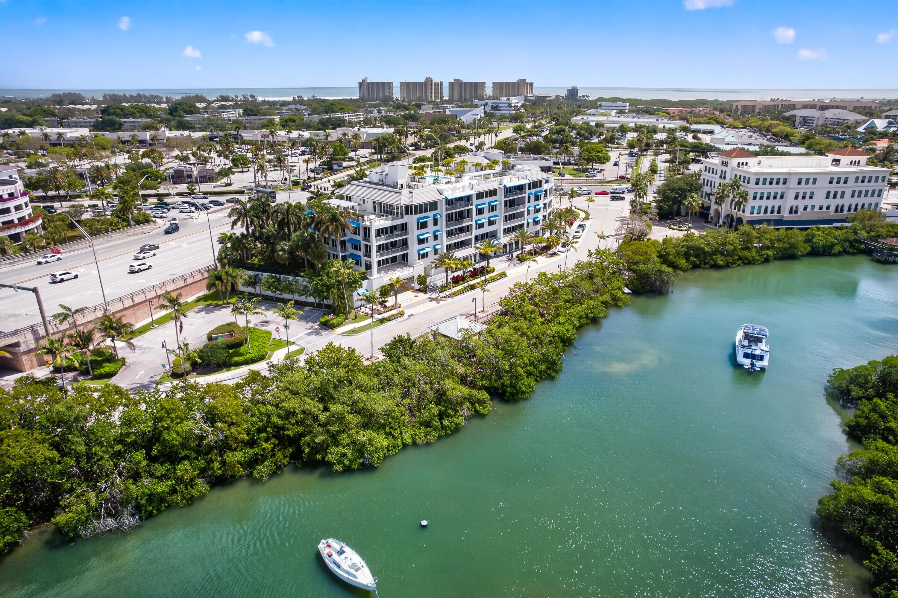 1 South Coastal Way, Unit 201 Jupiter, FL 33477 - Photo 35 of 40 an aerial view of a city with lots of residential buildings ocean and mountain view in back