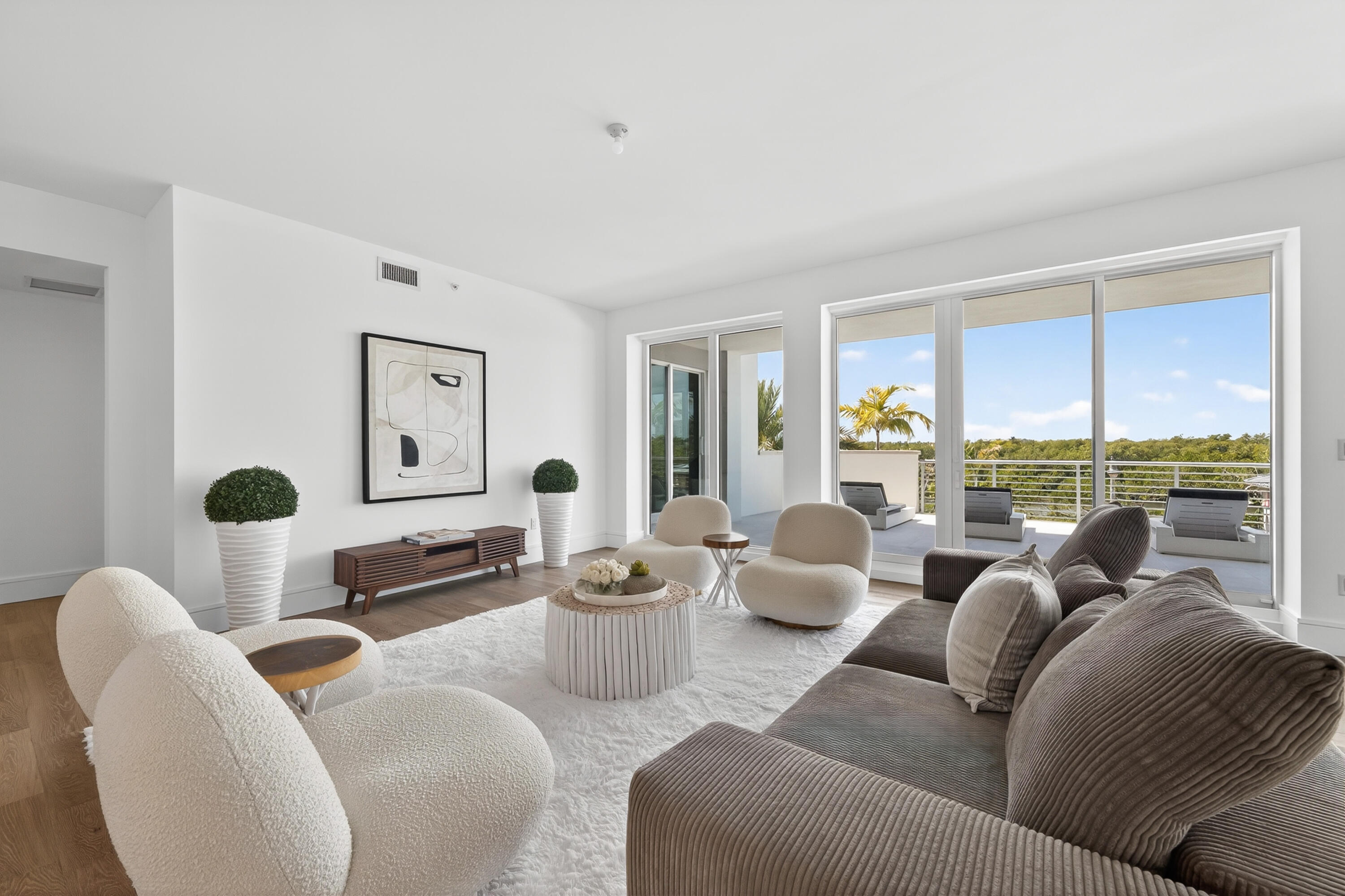 1 South Coastal Way, Unit 201 Jupiter, FL 33477 - Photo 5 of 40 a living room with furniture and a floor to ceiling window