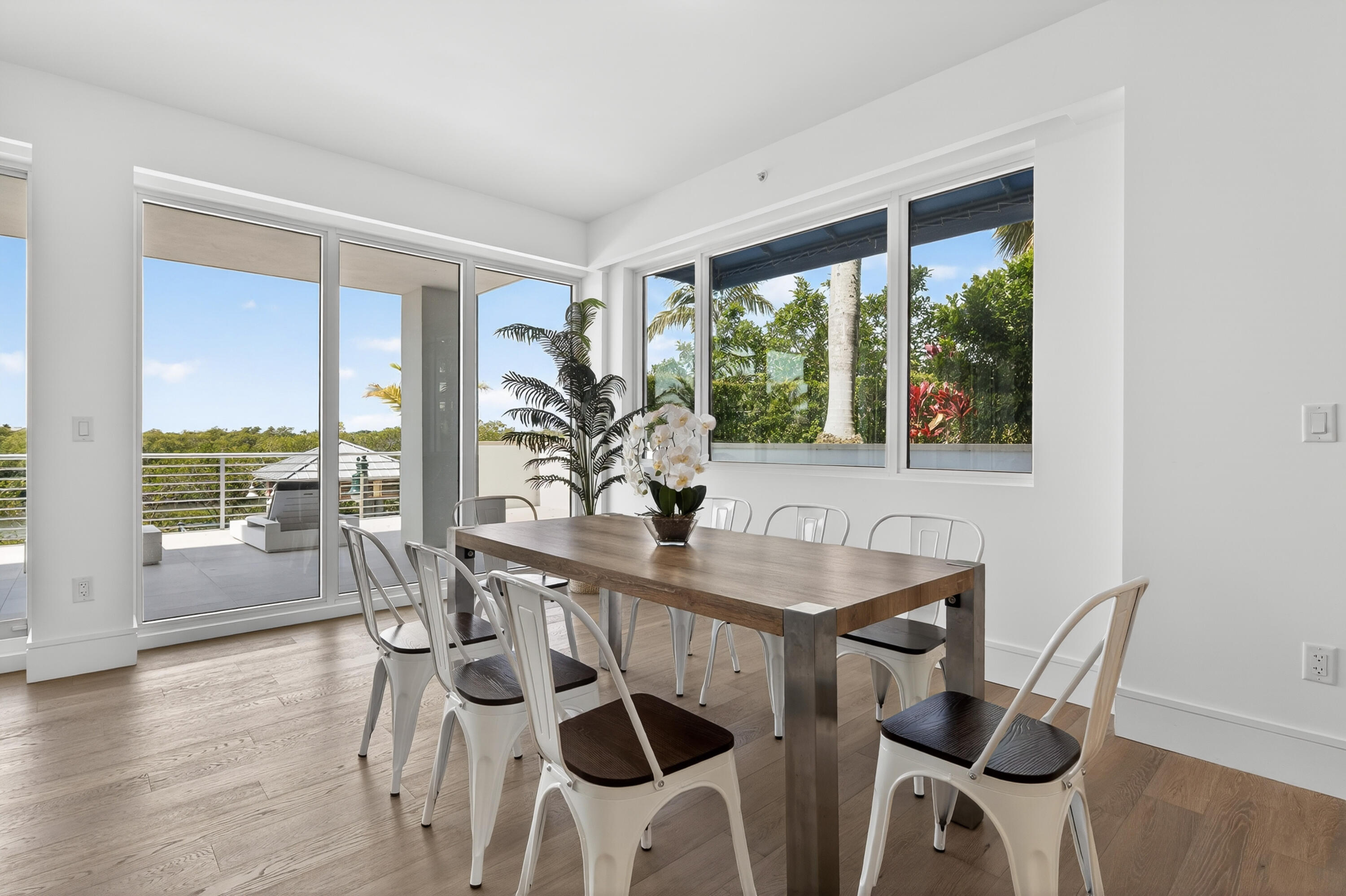 1 South Coastal Way, Unit 201 Jupiter, FL 33477 - Photo 7 of 40 a view of a dining room with furniture and wooden floor