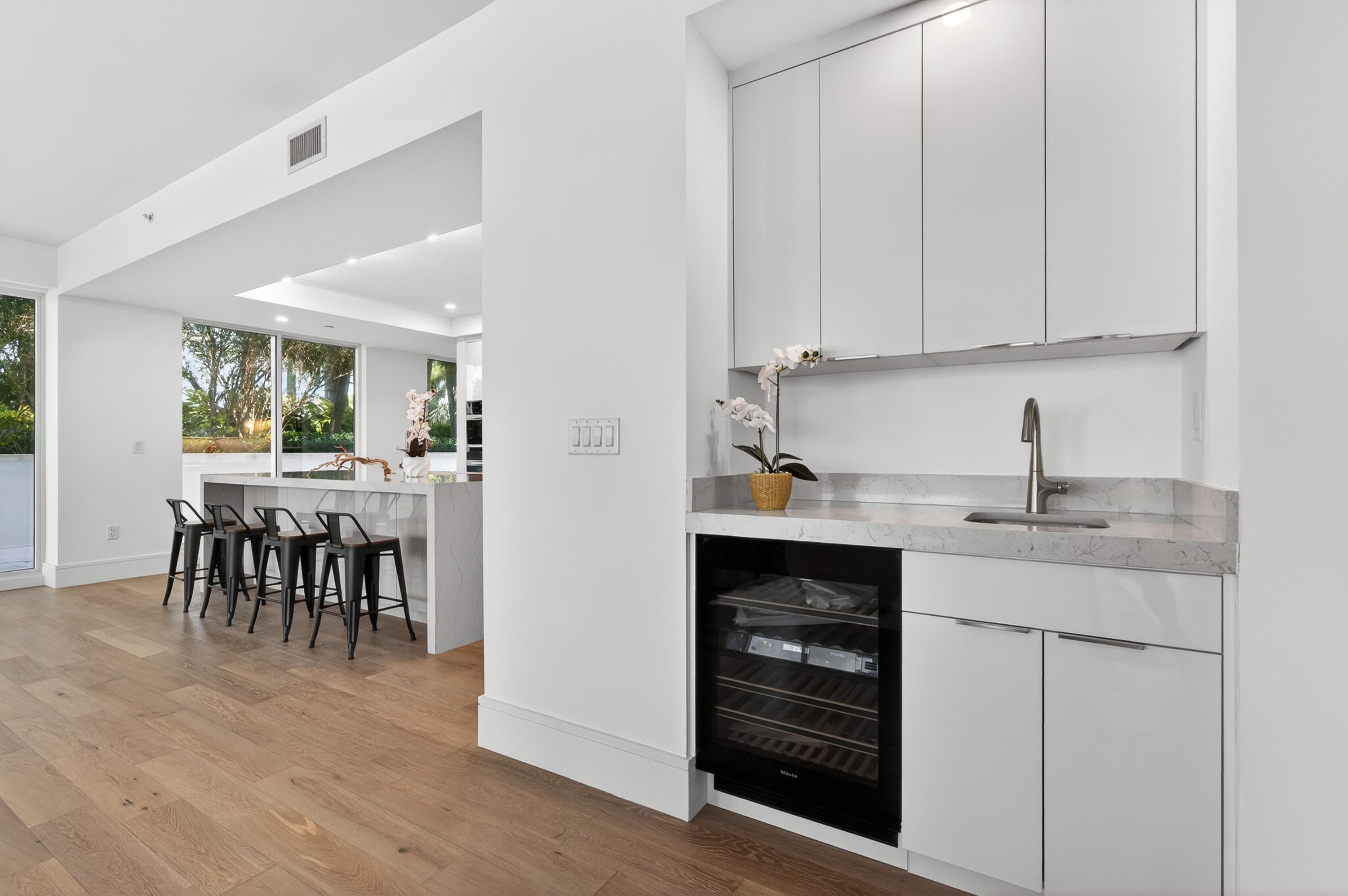 1 South Coastal Way, Unit 201 Jupiter, FL 33477 - Photo 8 of 40 a kitchen with white cabinets and sink