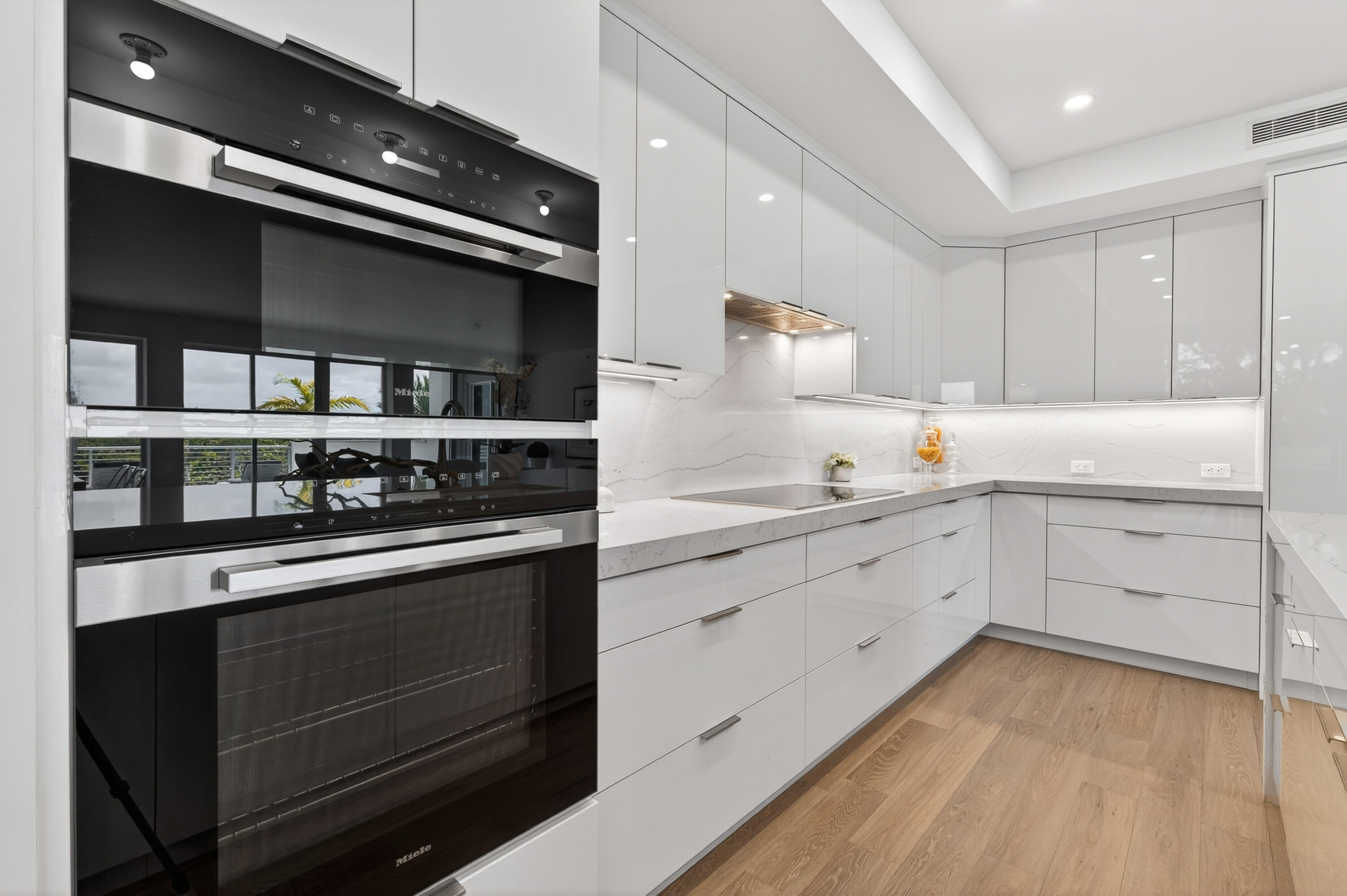 1 South Coastal Way, Unit 201 Jupiter, FL 33477 - Photo 10 of 40 a kitchen with stainless steel appliances white cabinets and a sink