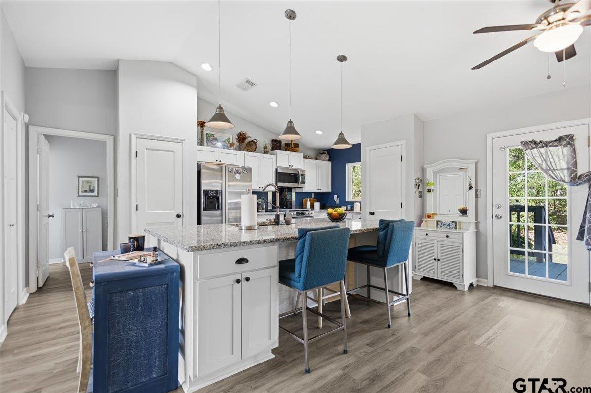 289 Acapulco Road Jefferson, TX 75657 - Photo 6 of 30 a room with stainless steel appliances kitchen island granite countertop furniture and a wooden floors