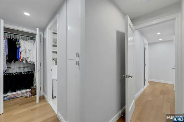 a spacious bedroom with a large bed and a flat screen tv