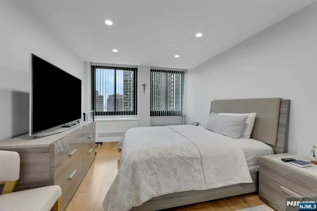 a bedroom with a bed and a flat screen tv