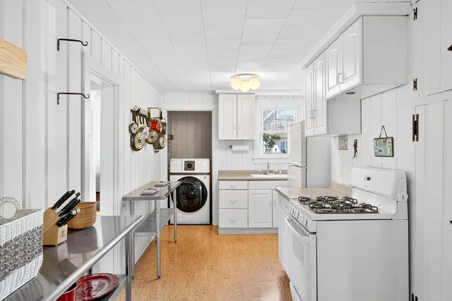 a kitchen with stainless steel appliances granite countertop a refrigerator a stove and a wooden floors