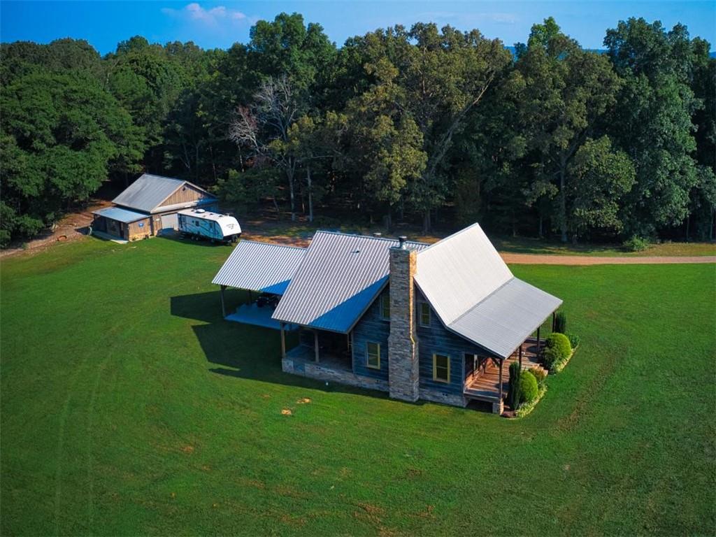 an aerial view of a house with backyard garden and outdoor seating