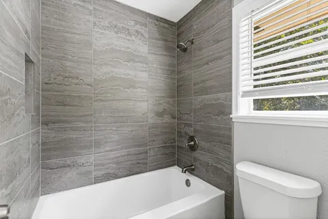 a bathroom with a toilet and bathtub