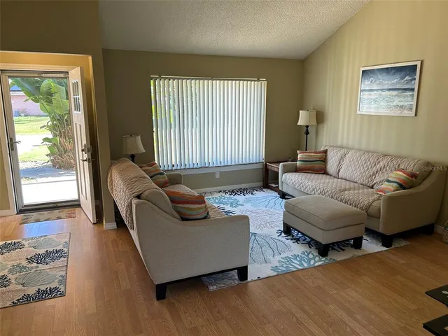 a living room with furniture and a large window