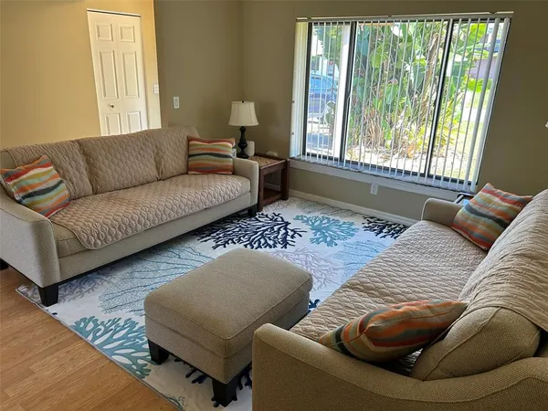 a living room with furniture and a large window