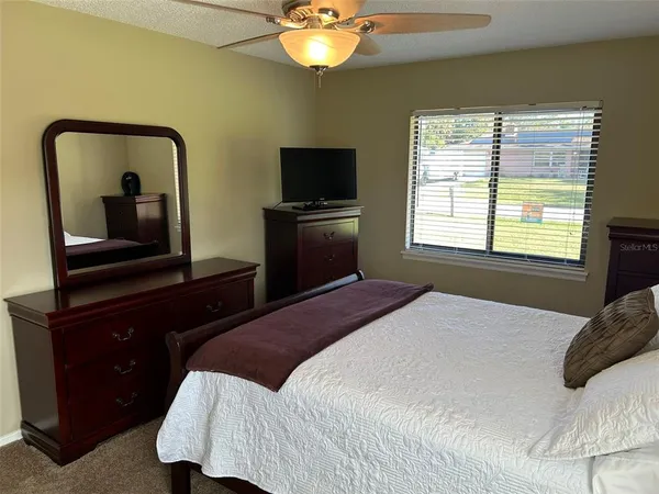 a bedroom with a bed and a television