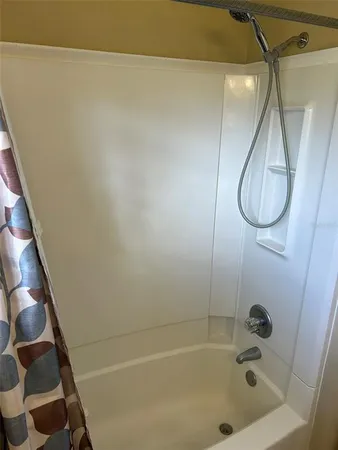 a bathroom with a bath tub and shower