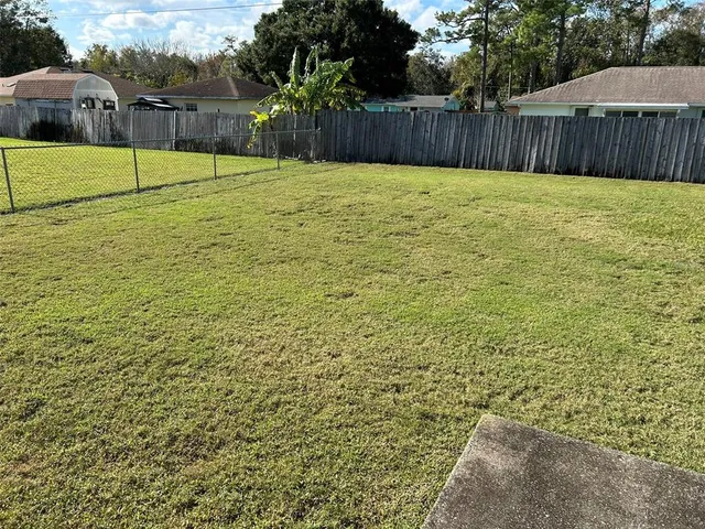 a view of a backyard with a fence