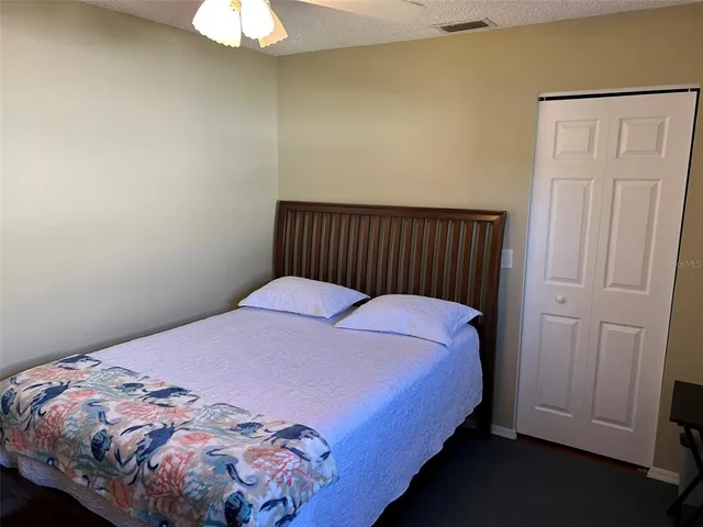 a bed sitting in a bedroom next to a window