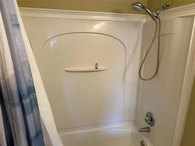 a bathroom with a shower and a tub