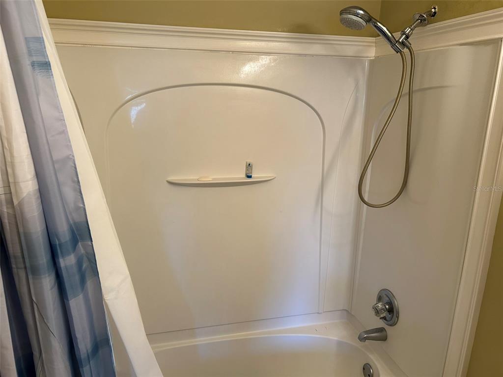 3424 Unity Tree Drive Edgewater, FL 32141 - Photo 6 of 34 a bathroom with a shower and a tub