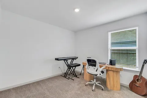 a bathroom with a granite countertop sink toilet and mirror