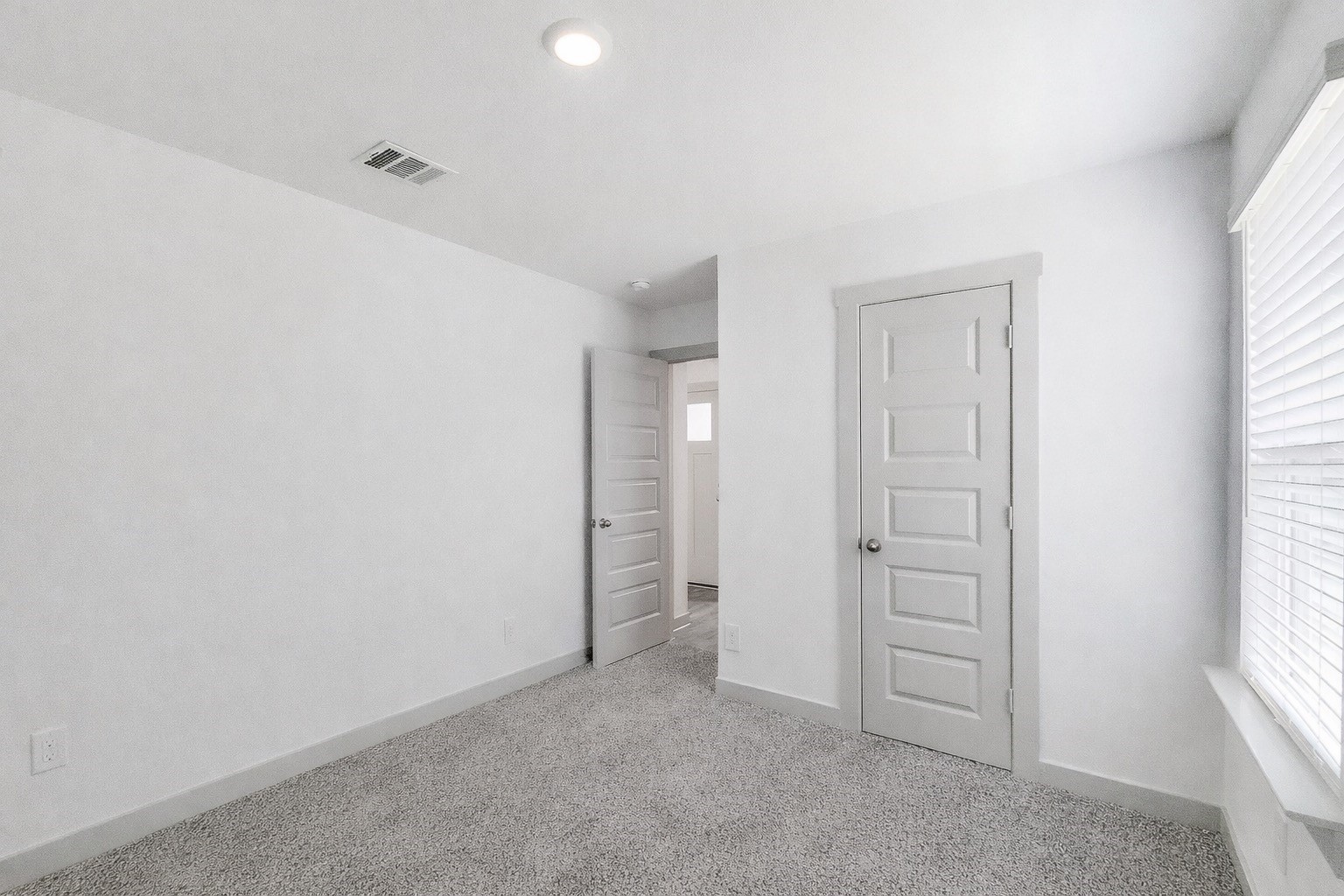 10647 Cascade Crk Drive Rosharon, TX 77583 - Photo 17 of 29 Bedroom 2 located in the front of the home, large window, crisp white walls, and a great closet for daily use