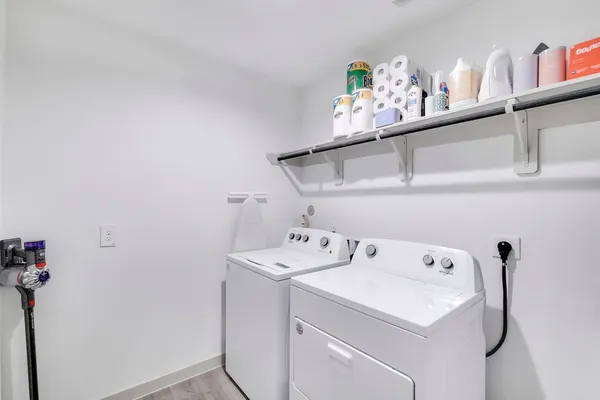 a view of a porch with chairs and a potted plant