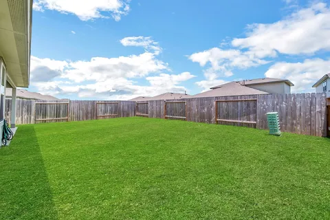 a view of a house with a yard and sitting area
