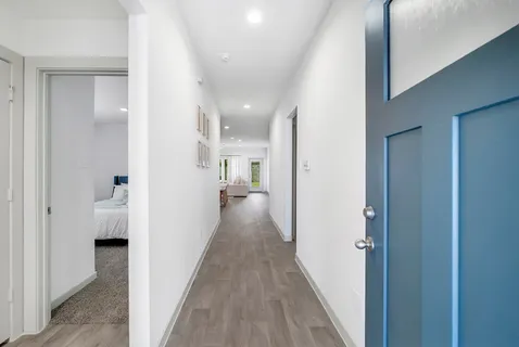 a view of hallway with wooden floor