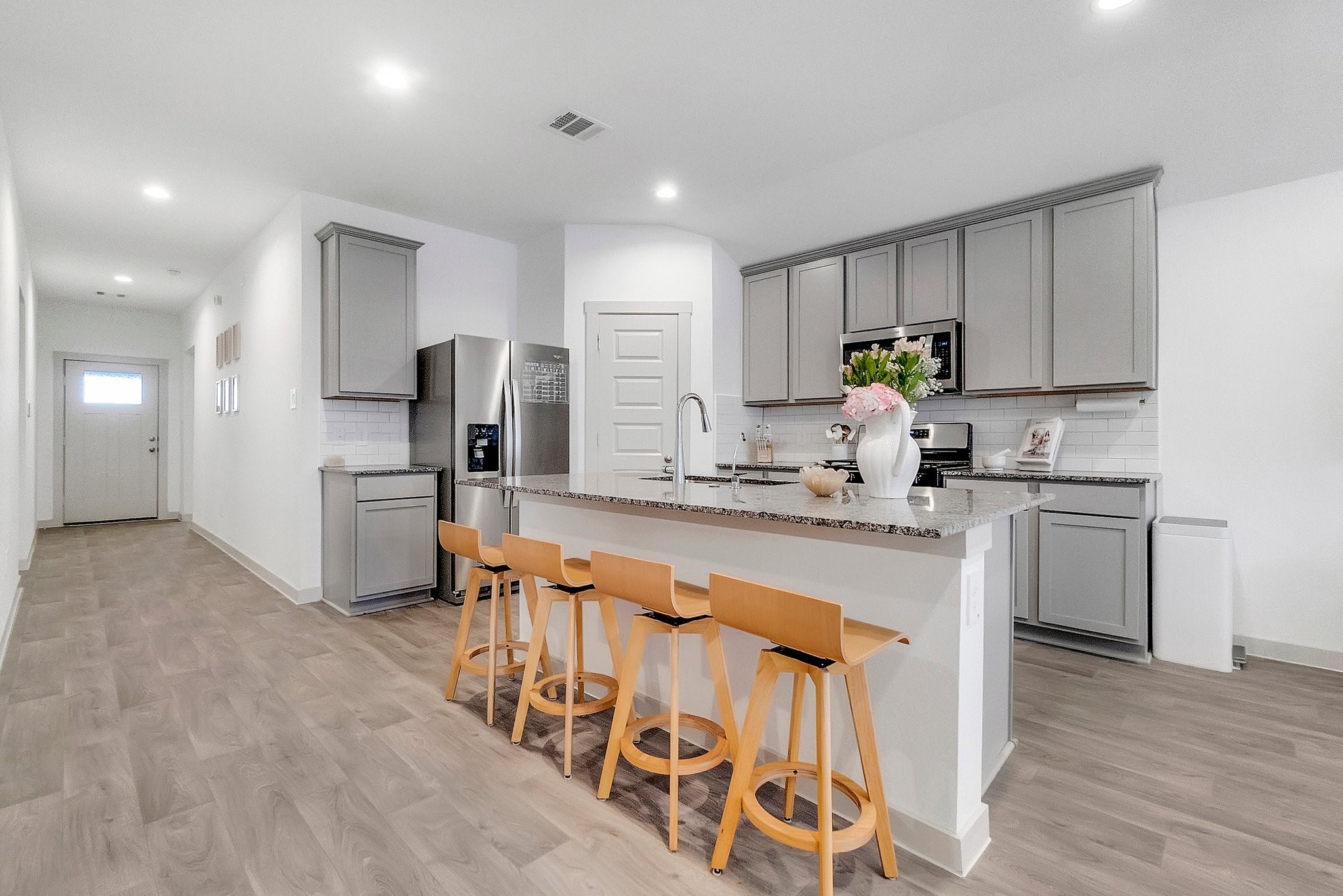 10647 Cascade Crk Drive Rosharon, TX 77583 - Photo 4 of 27 a kitchen with stainless steel appliances kitchen island granite countertop a refrigerator and a stove top oven