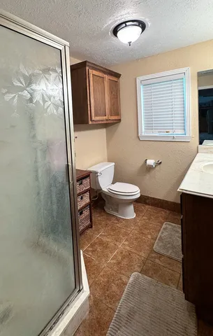 a bathroom with a toilet sink and shower