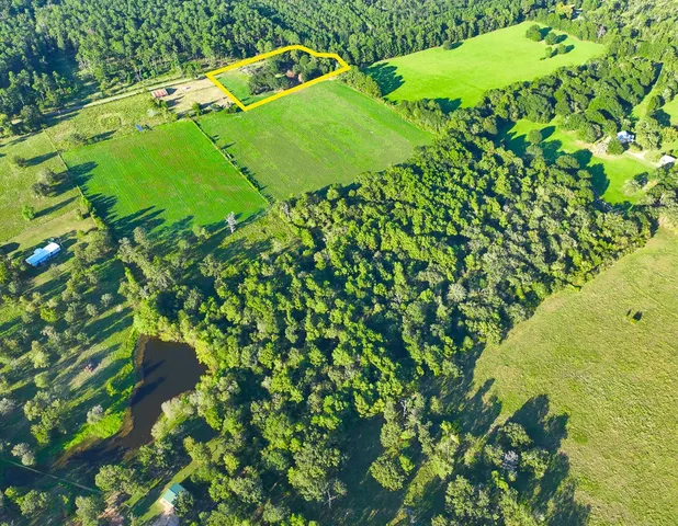 an aerial view of a tennis ground and a yard