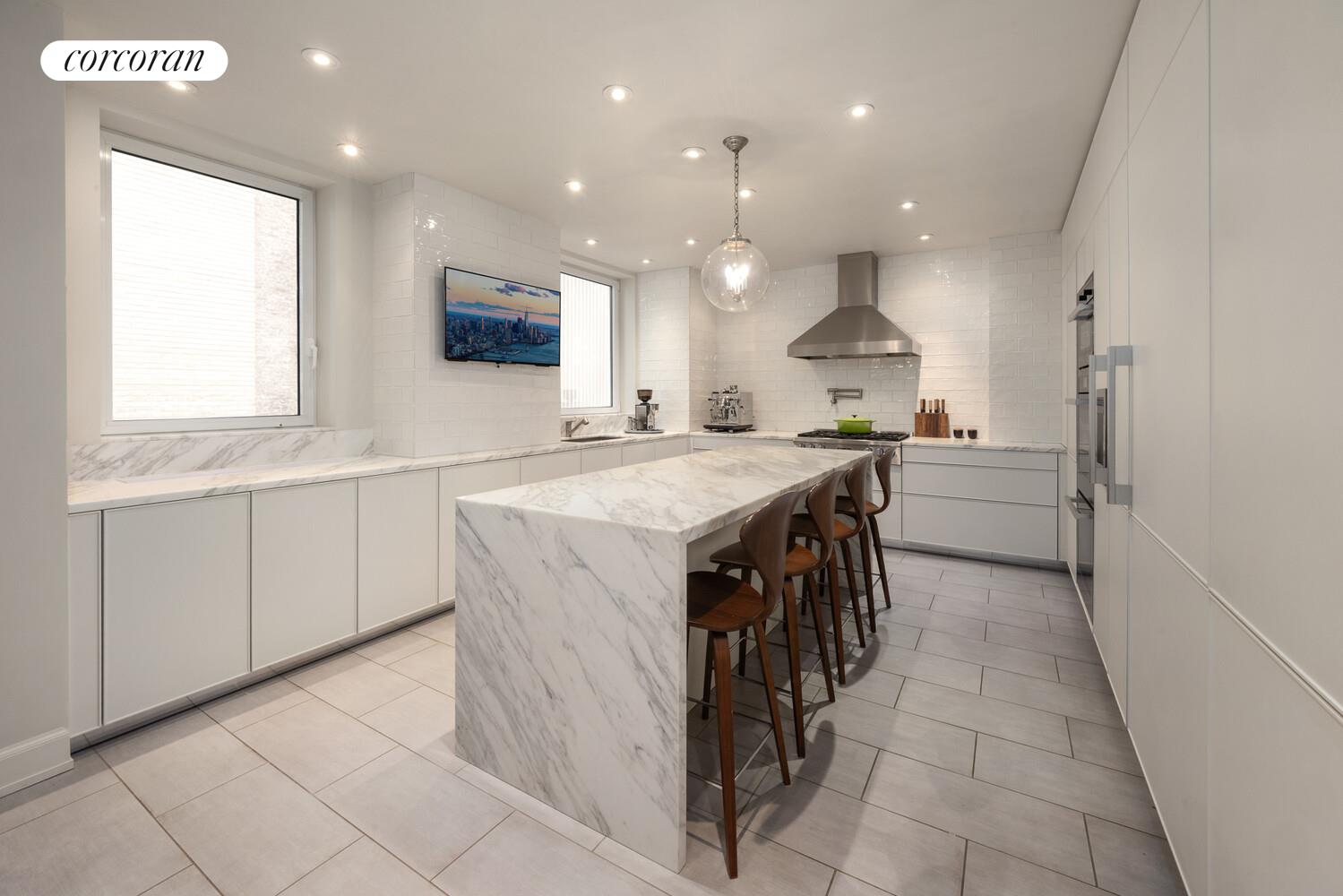 3 East 84th Street, Unit 3 Manhattan, NY 10028 - Photo 13 of 24 a kitchen with stainless steel appliances granite countertop a stove a sink and a refrigerator