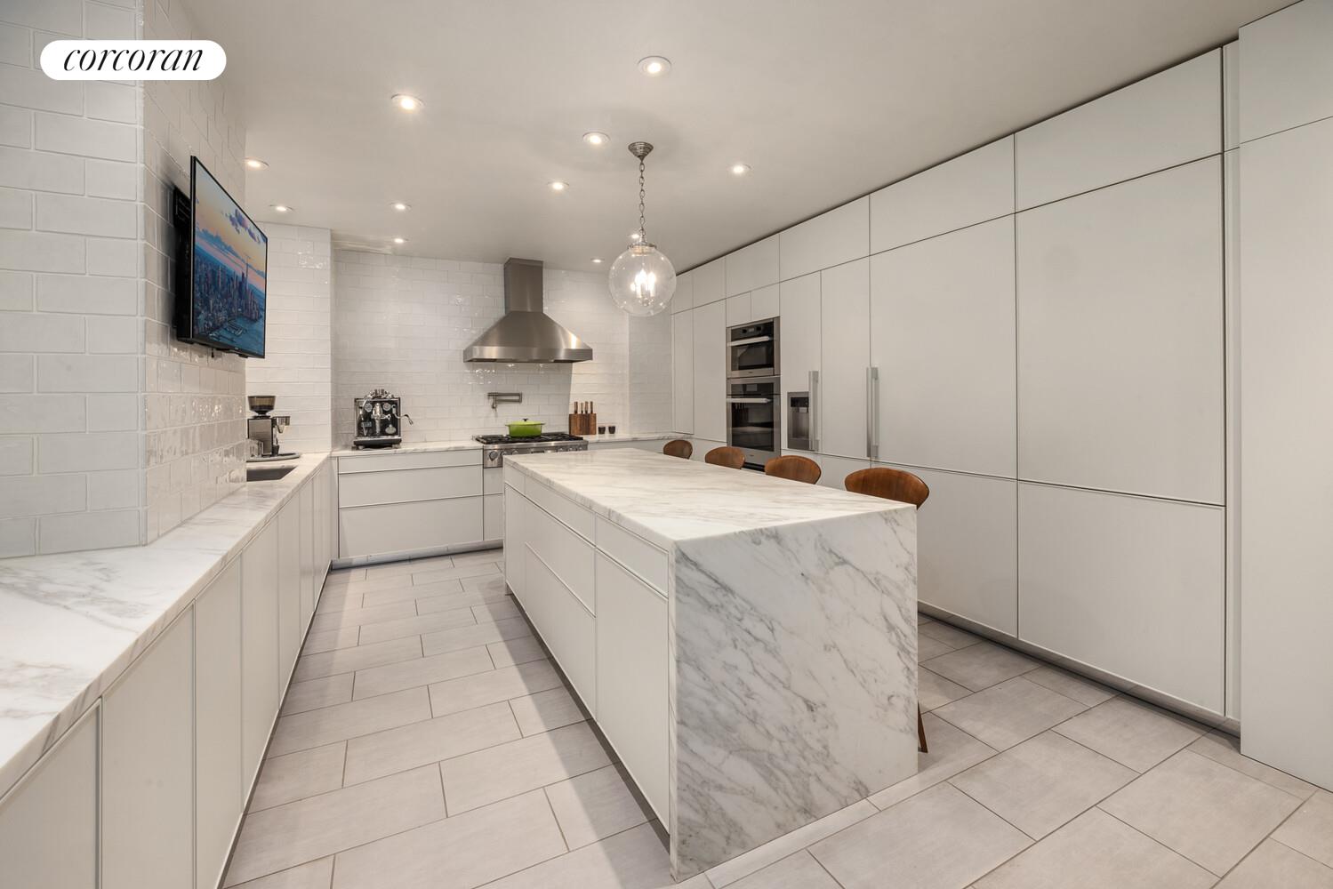 3 East 84th Street, Unit 3 Manhattan, NY 10028 - Photo 14 of 24 a large white kitchen with a stove a sink and a refrigerator