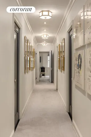 a view of a hallway with wooden floor and a living room