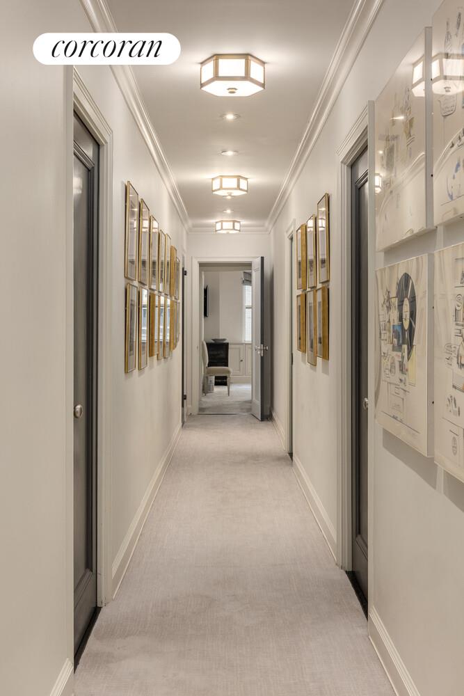 3 East 84th Street, Unit 3 Manhattan, NY 10028 - Photo 15 of 24 a view of a hallway with wooden floor and a living room