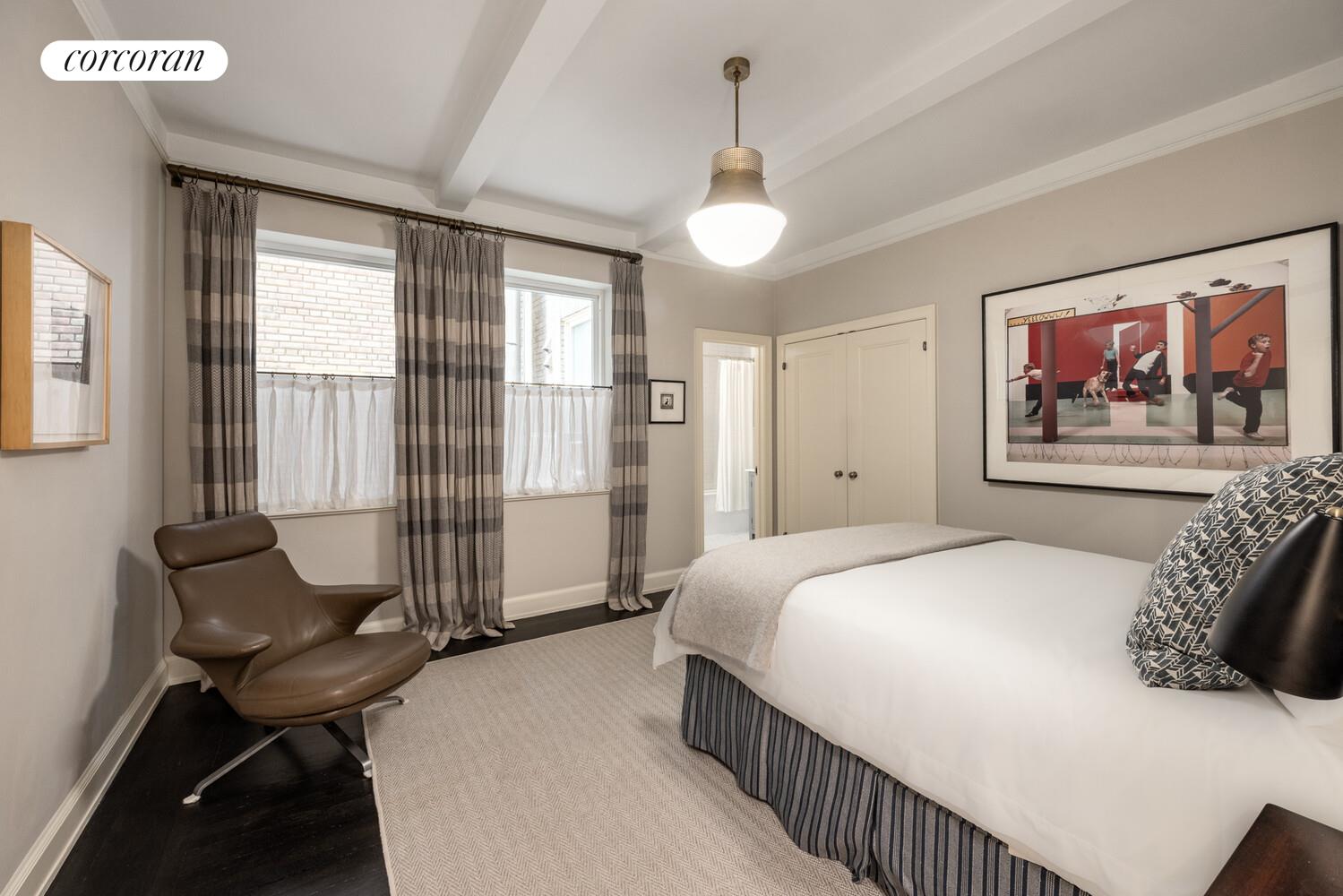 3 East 84th Street, Unit 3 Manhattan, NY 10028 - Photo 22 of 24 a bedroom with a bed and a chandelier