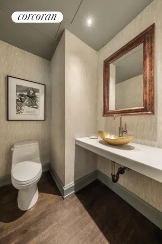 a bathroom with a toilet sink and mirror