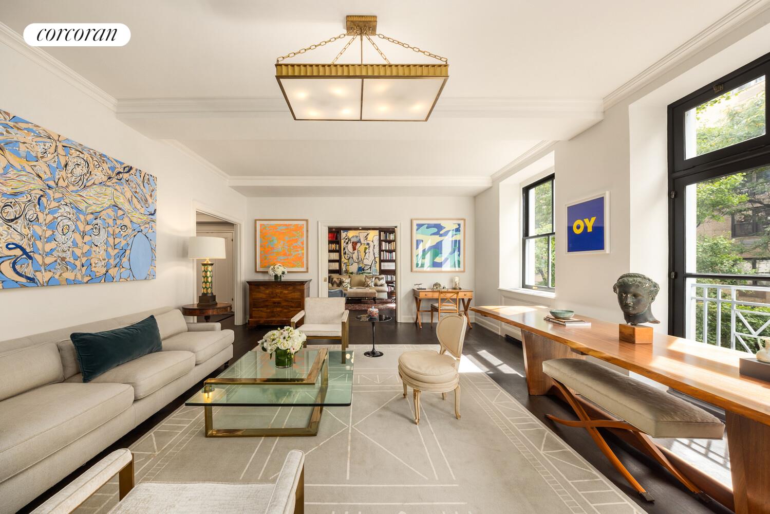 3 East 84th Street, Unit 3 Manhattan, NY 10028 - Photo 2 of 24 a living room with furniture and a large window