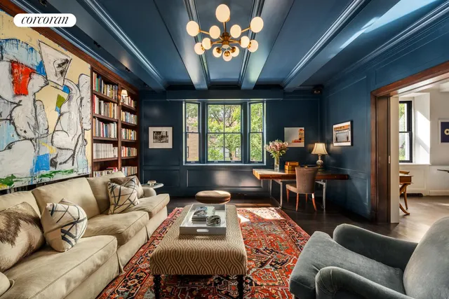a living room with furniture a chandelier and a large window