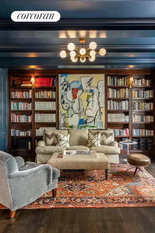 a living room with furniture and a floor to ceiling window next to a large window