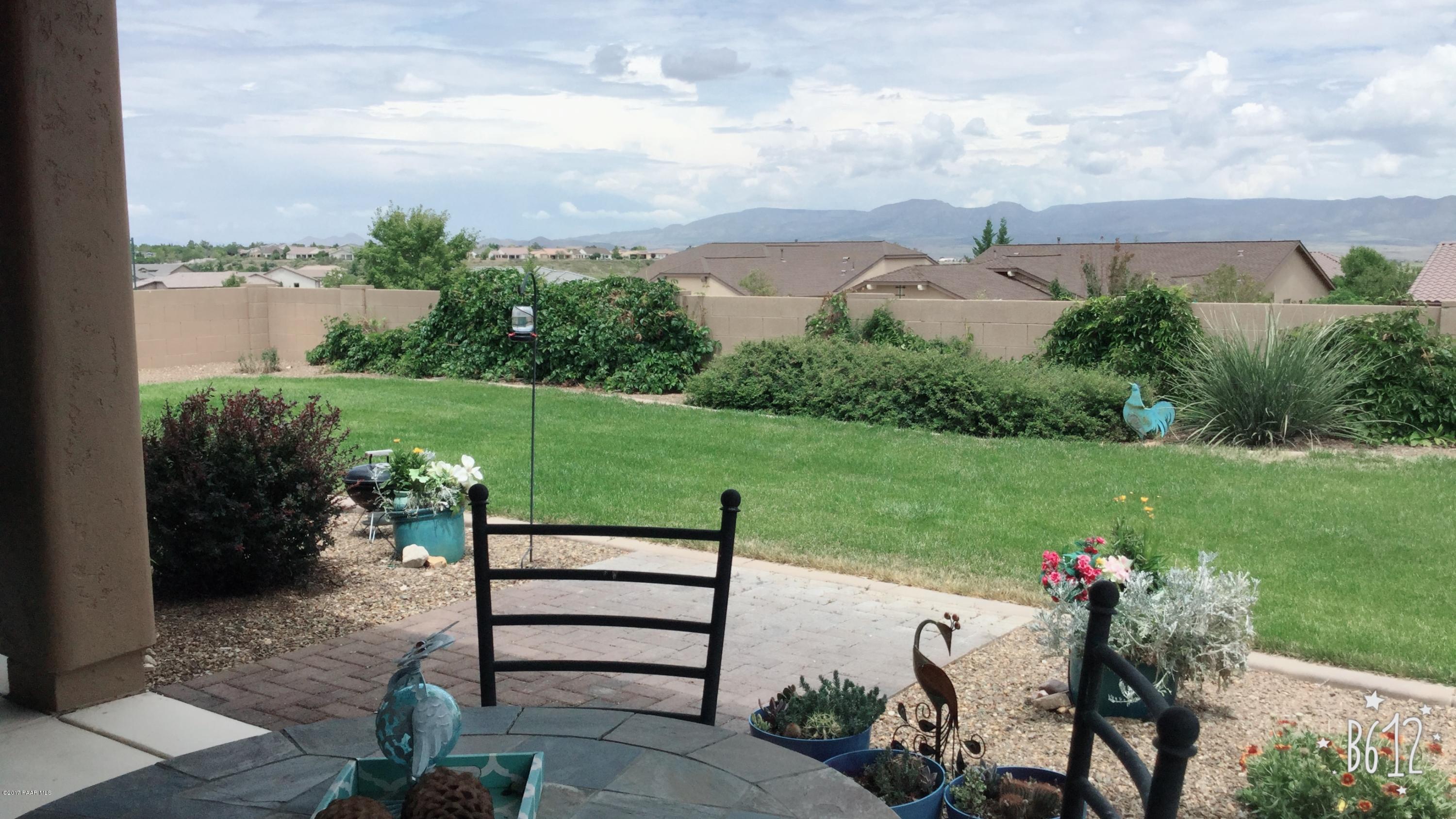 1197 Rusty Nail Road Prescott Valley, AZ 86314 - Photo 37 of 40 a view of a table and chairs in the garden