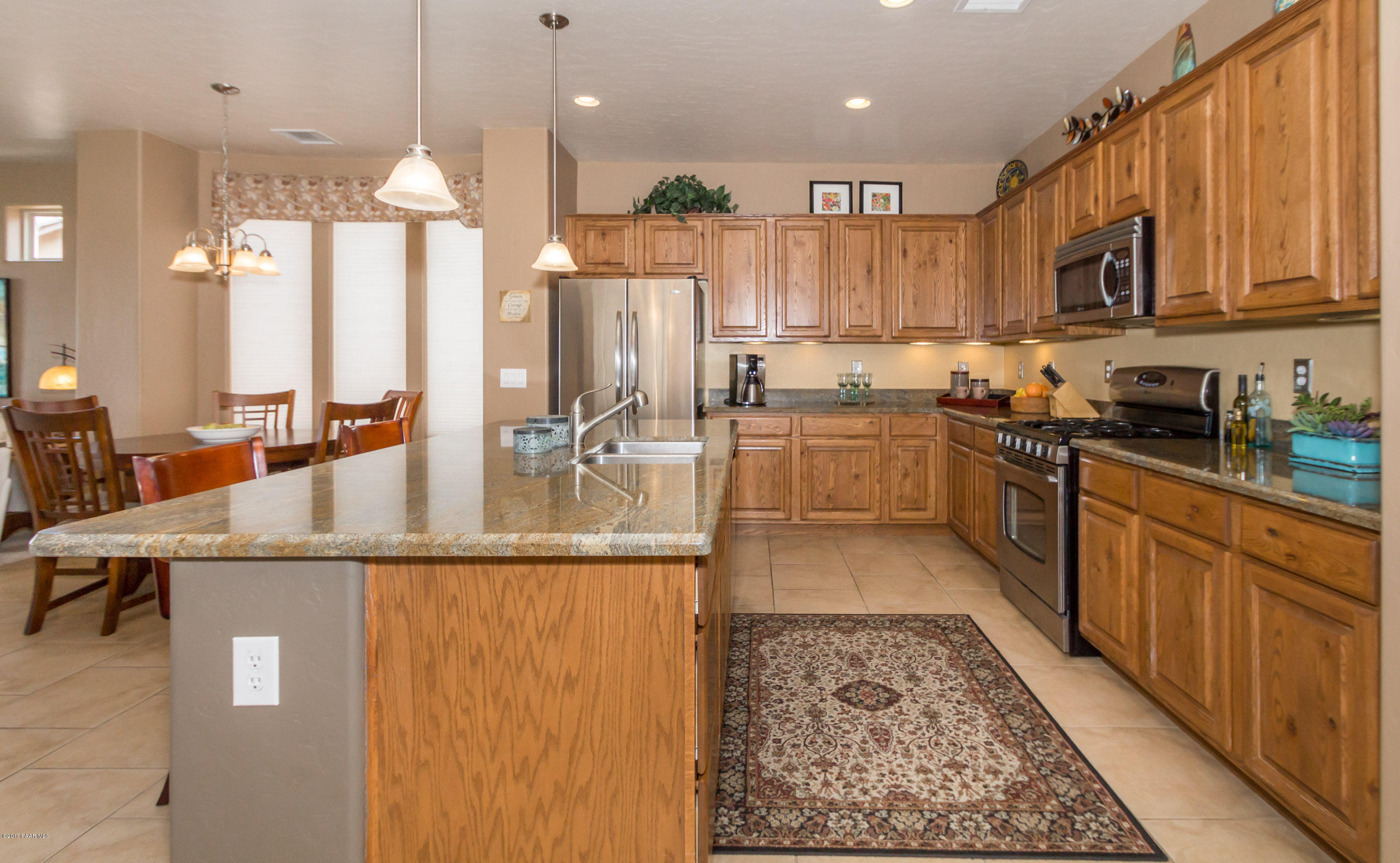 1197 Rusty Nail Road Prescott Valley, AZ 86314 - Photo 8 of 40 a kitchen with stainless steel appliances granite countertop a sink and a refrigerator